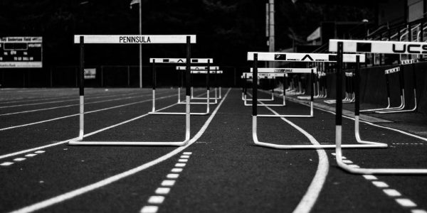 Monochrome image of hurdles on an empty sports track, perfect for athletic themes.